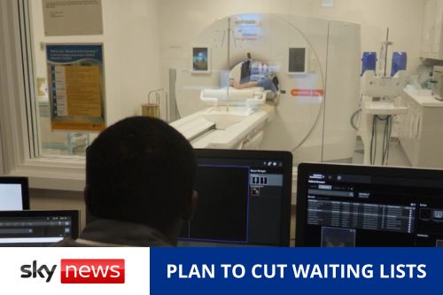 A woman being scanned by a CT scanner, with a technician looking at screens